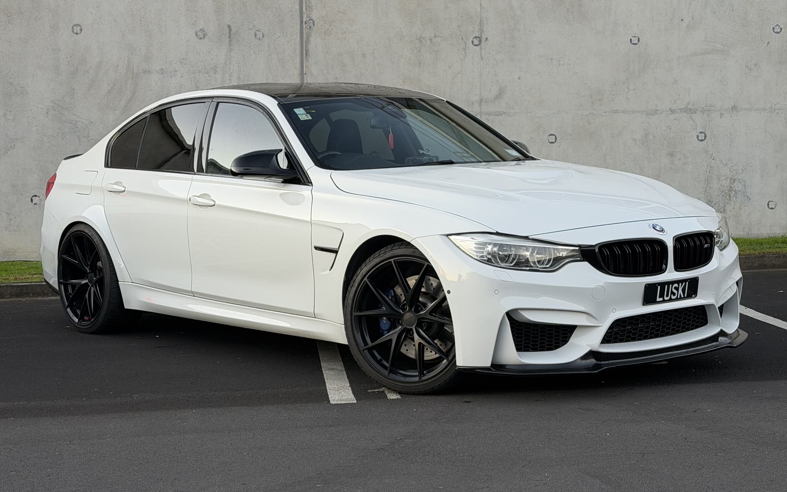 2015 BMW M3 F80 in Alpine White, front three-quarter view