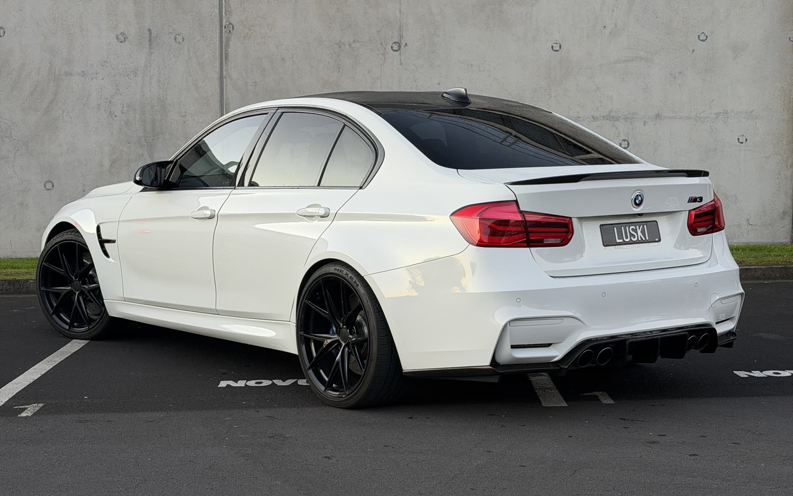 2015 BMW M3 F80 rear three-quarter view with boot spoiler